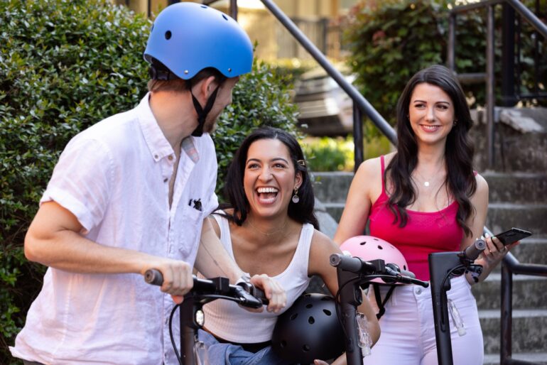 EAST Framework, young people laughing with e-scooters